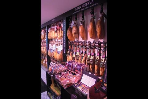 Among the products hanging on the wall are cured pigs’ legs